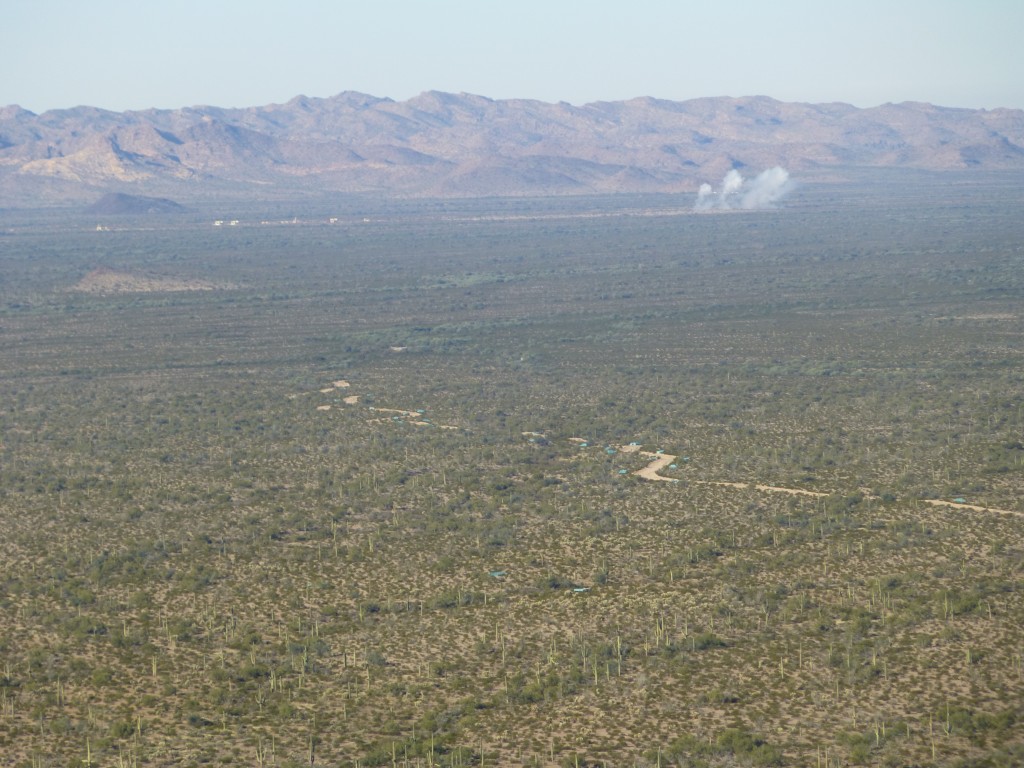 A long telephoto shot of bombs exploding ten miles to the west