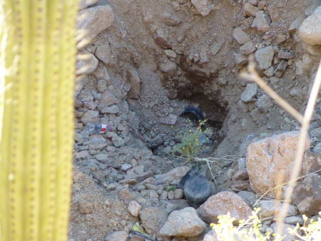 Looking down from the top of the waterfall on to the hole in the sand at the base