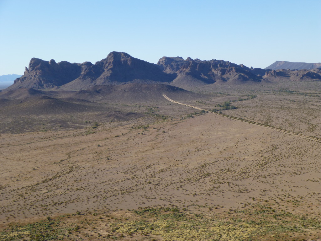 The double road, its west end terminating at the central part of the Aguila Mountains